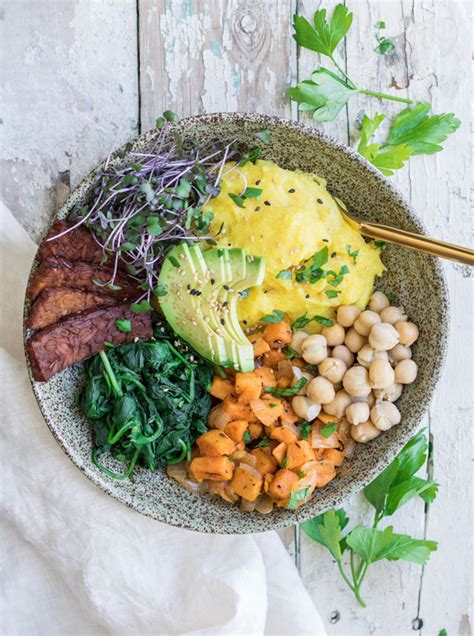 Verb with object nourishing to sustain with food or nutriment; Nourishing vegan breakfast bowl with tempeh bacon ...
