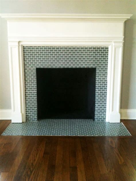 Exposed brick is a look that can complement many styles of home. gray brick tile clad firebox surround and hearth beautifying white modern mantle over wooden ...