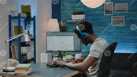 Person Working With Sketch Of Blueprint Plan On Computer Stock Photo