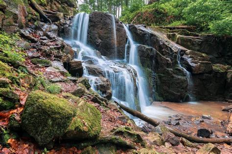 Beautiful Waterfall Comes Out Of A Huge Rock In The Forest
