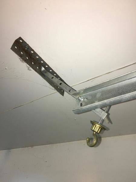 Whenever a torsion spring is installed, it is stretched horizontally along the shaft to keep the coils from binding. Garage door track hangers location - DoItYourself.com ...