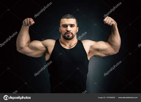 Strong Man Showing Muscles — Stock Photo © Alexfedorenko 167956098