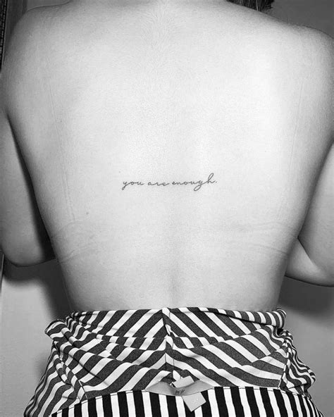 You Are Enough Lettering Tattoo Located On The Back