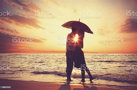 Couple Kissing At The Beach In Sunset Stock Photo Download Image Now