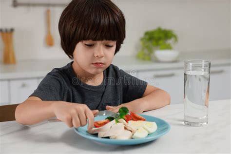 Cute Little Boy Refusing To Eat Dinner In Kitchen Stock Image Image