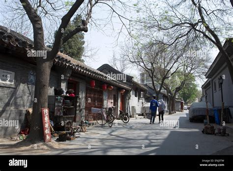 A Traditional Hutong Narrow Street Or Alleyway Bordered By Courtyard