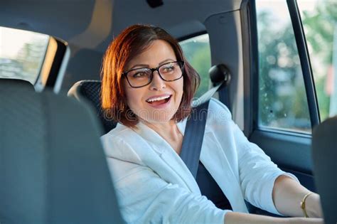 Portrait Of Business Elegant Middle Aged Woman In Car In Back Passenger