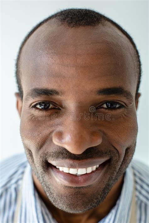 Portrait Of Smiling Afro American Man Standing Against White Background