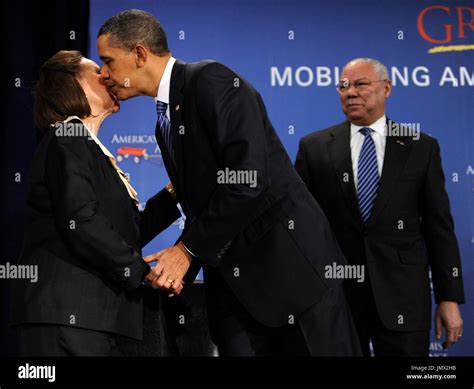 United States President Barack Obama, center, kisses Alma Powell, wife
