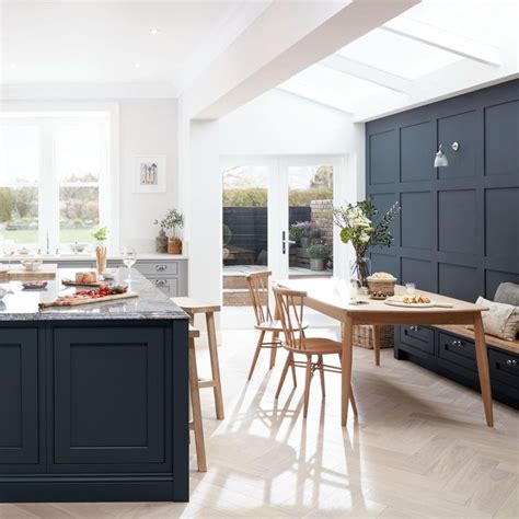 An Open Kitchen And Dining Room With Blue Cabinets