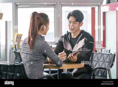 Trainer Counseling A Trainee At Health Club Stock Photo Alamy