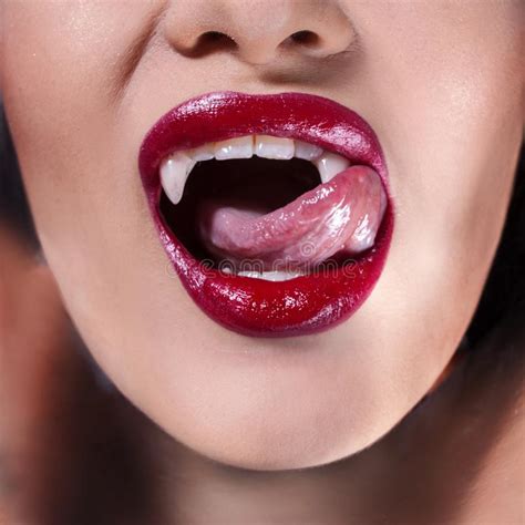 Vampire Women`s Lips With Red Lipstick Tongue Licking Vampire Fangs