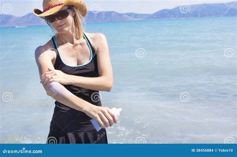 Woman Applying Sun Block Lotion While At The Beach Stock Photo Image Of Creme Lake