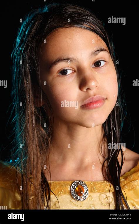 Close Up Portrait Of A Bright Cute Smart Brunette Girl 12 Years Old In A Yellow Silk Dress She
