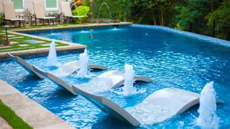 There is nothing like a lit up pool in the backyard at night, with a couple lit up streams of water arching into the pool. Cool Swimming Pool Water Feature Ideas - Pool Research