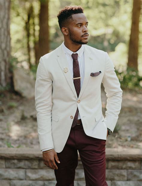 groom in a cream jacket and burgundy pants groomsmen outfits groom outfit groom attire