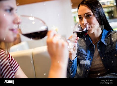 Female Friends Drinking Red Wine Stock Photo Alamy