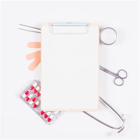 Free Photo Blank Paper On Clipboard Over The Medical Equipments On