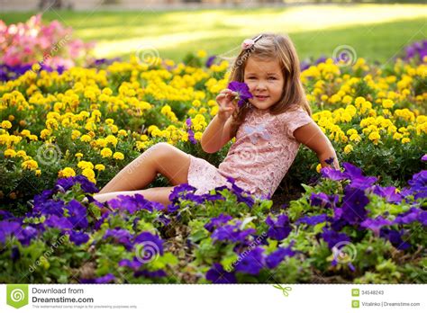 Happy Beautiful Little Girl With Flowers Stock Image