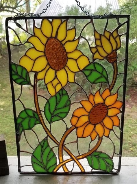 A Stained Glass Window With Sunflowers On It