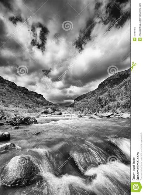 River Landscape In Drakensberg With Dramatic Clouds And Mountain Stock