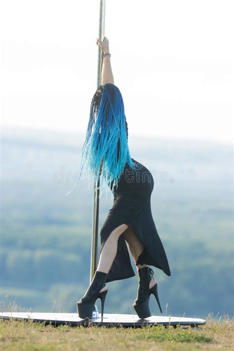 Woman With Blue Braids On High Heels Dancing By The Pole On Nature