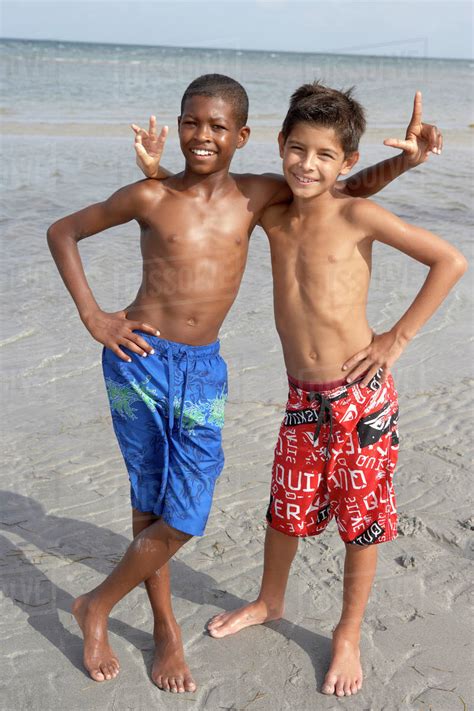 Playful Boys Enjoying The Beach Together Stock Photo Dissolve