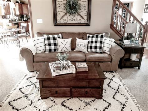 A Living Room Filled With Furniture And Pillows On Top Of A White