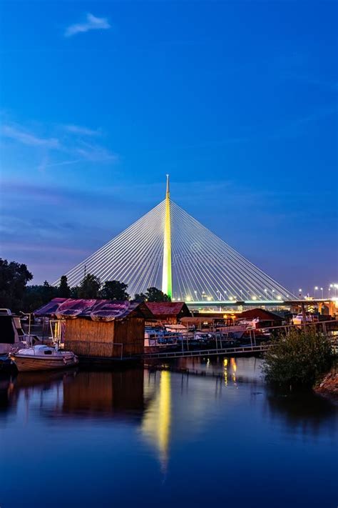 Side View Of Ada Bridge At Night With Reflection Over Belgrade Marina
