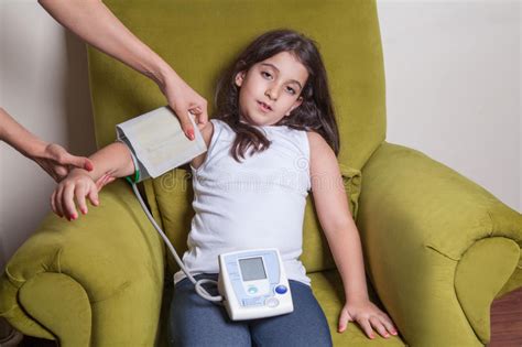 Doctor Checking Blood Pressure Of Small Beautiful Middle Eastern Girl