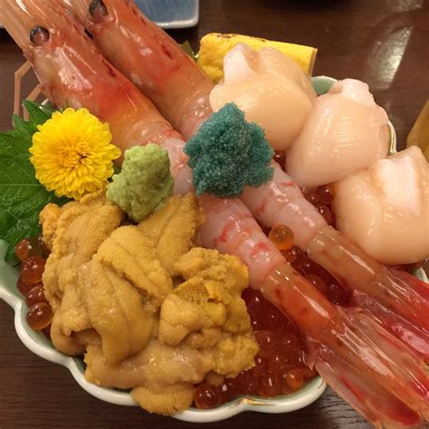 A Bowl Filled With Lots Of Different Types Of Food On Top Of A Wooden Table