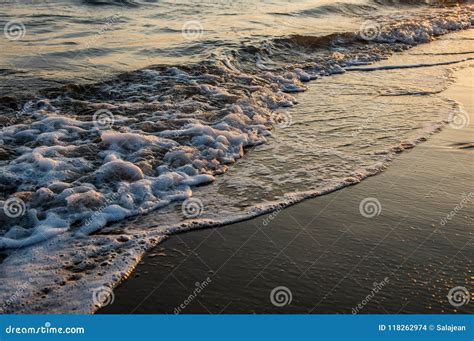 Waves Approaching Sandy Beach During Sunset Stock Photo Image Of
