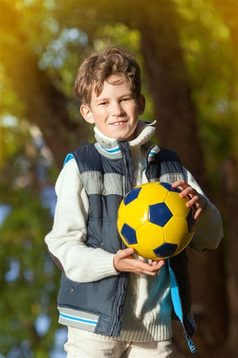 The Young Boy Holds Ball For Soccer Stock Photo Image Of Childhood