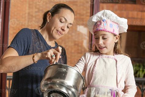 Mother And Daughter Having Fun In The Kitchen Baking Together Preparing Cupcakes With Mom