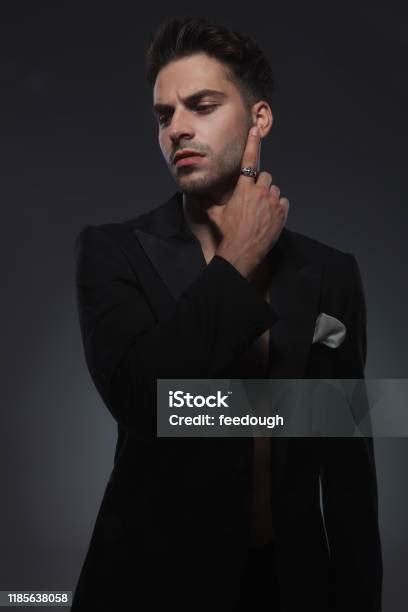 Dramatic Cool Guy Touching Chin And Standing In A Fashion Pose Stock