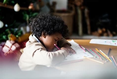 Premium Photo African Kid Enjoying A Coloring Book