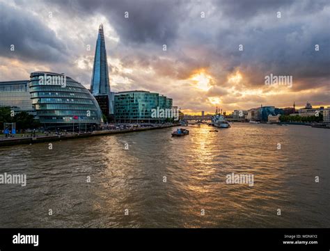 River Thames Illuminated By Sunset With The Famous Landmarks Along The
