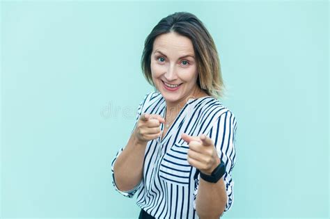 satisfied attractive joyful adult woman pointing to camera with fingers choosing you making