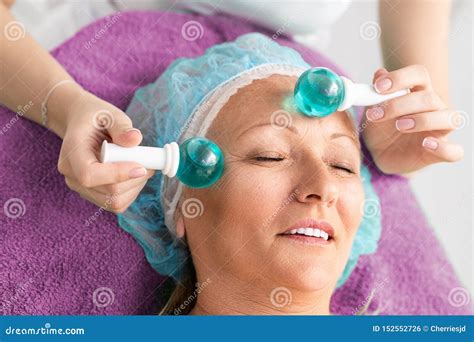 Senior Woman Getting Facial Massage In Spa Center Stock Photo Image