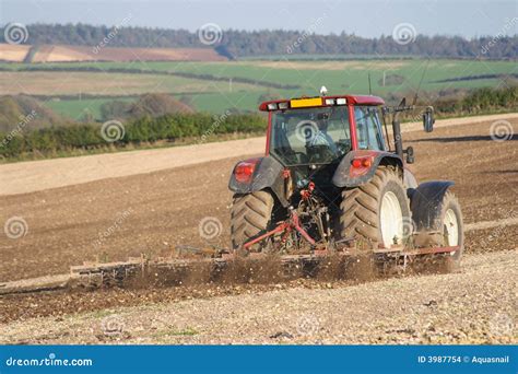 Tractor Ploughing Field And Cultivating Land In Springtime Royalty Free
