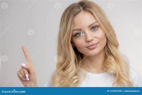 A Good Looking Young Woman Showing To The Copy Space Stock Photo