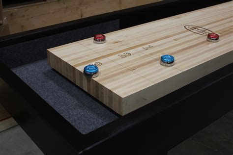 Shuffleboard is a simple but addictive game that involves sliding metal weights (also known as pucks or quoits) down a smooth wooden table to a scoring area at the opposite end. Is Your Shuffleboard Table's Playing Surface Really 3 ...