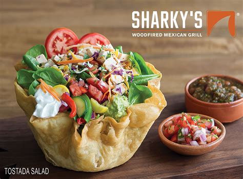 Our burrito filled with frijoles, tomato, lettuce, cheese, juice steak, carne al burrito filled with frijoles shredded lettuce cheese, grilled red and green bell peppers, tomatoes tostadas. Sharky's Woodfired Mexican Grill