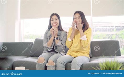 Lesbian Asian Couple Watching Tv Laugh In Living Room At Home Sweet Couple Enjoy Funny Moment