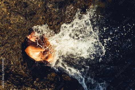 Woman And The Sea The Naked Woman Curled Up In A Tangle Among The Rocks Of The Sea Shore The
