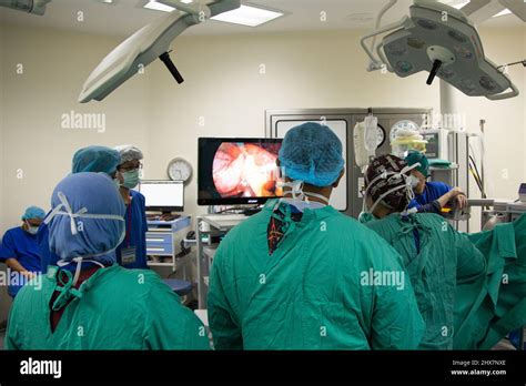 Surgeons Wearing Scrubs In A Operating Theater Performing Laparoscopic