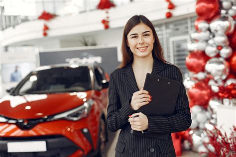 Delighted Young Female Car Dealer In Car Salon · Free Stock Photo