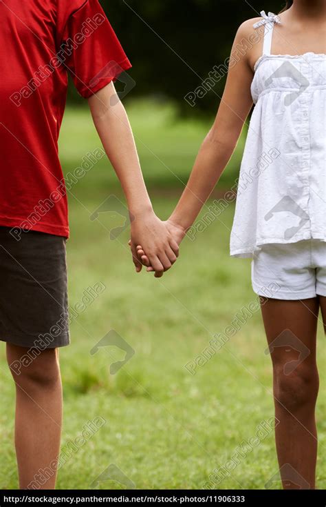 Children In Love Boy And Girl Holding Hands Stock Photo