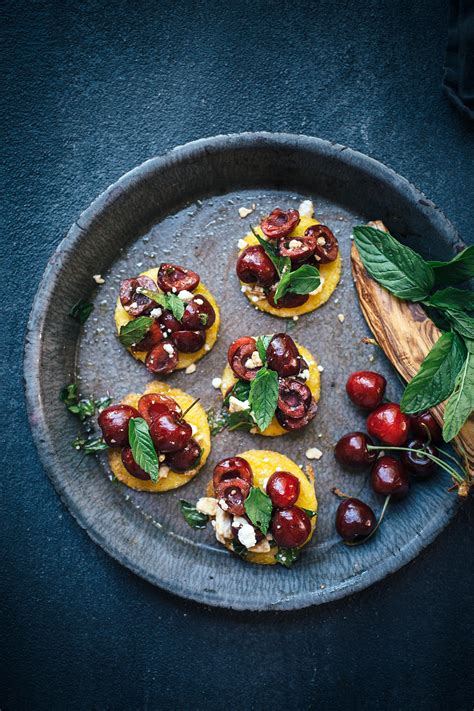 After cutting the polenta tube into slices and placing them onto a cookie sheet, i topped each round with some of the tomato mixture. Cherry Mint Polenta Bruschetta recipe