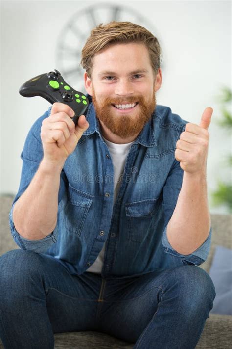 Happy Man Playing Games At Home Showing Thumb Up Stock Photo Image Of